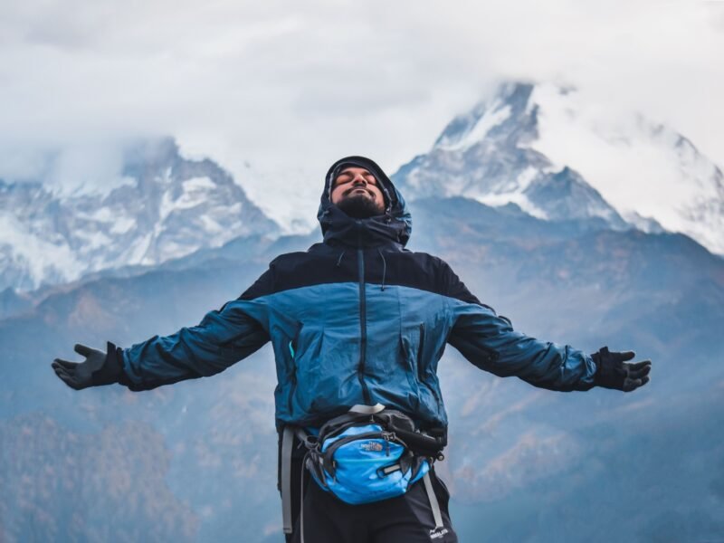 Man with arms open breathing in fresh mountain air